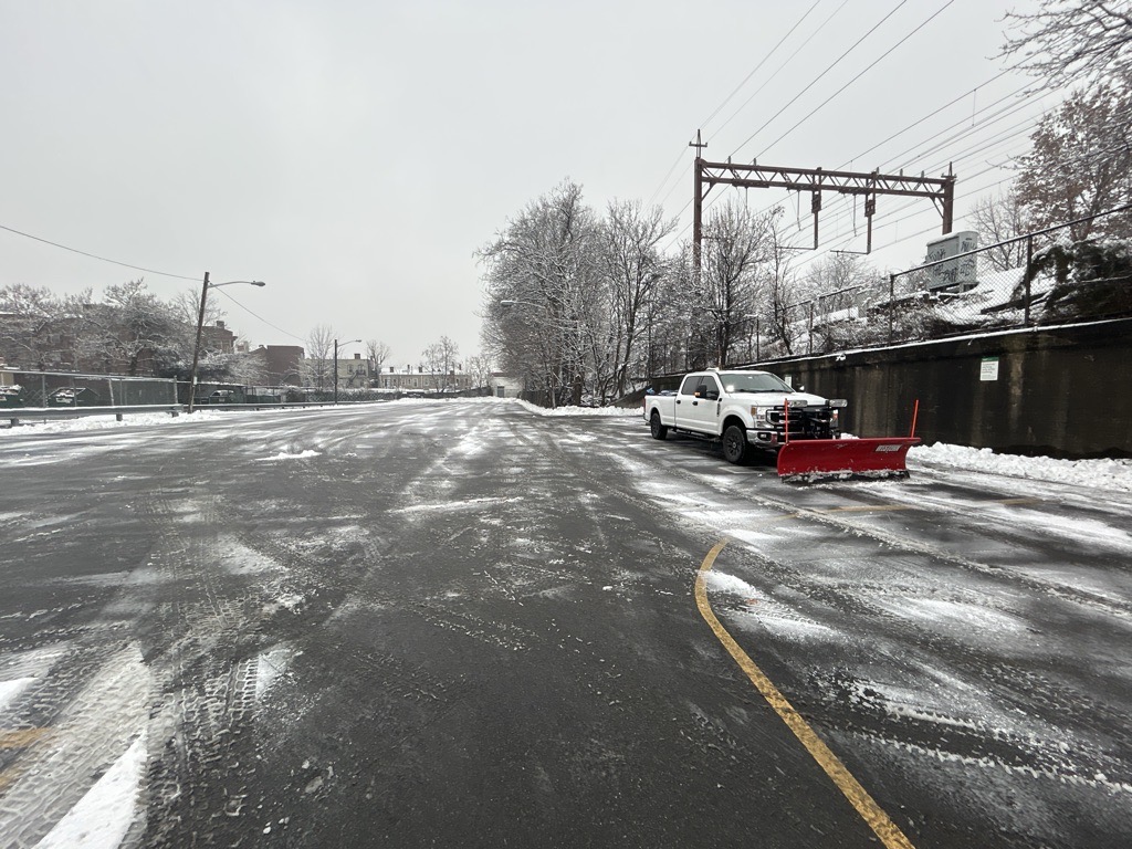Commercial parking lot with snowplow truck